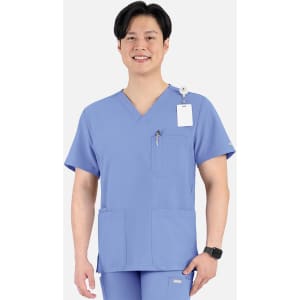 A blue men's V-neck top featuring four pockets and a logo, worn by a smiling model.