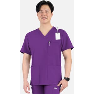 A purple men's V-neck top with four pockets, featuring a logo and worn by a smiling model.