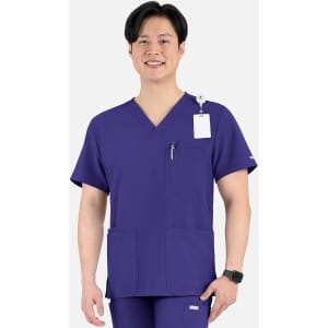 A purple V-neck top with four pockets, featuring a logo, worn by a smiling man.