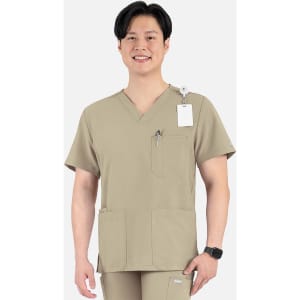 A men's V-neck top in a tan colour with four pockets and a logo, modelled by a man.