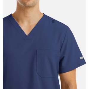 A navy blue men's V-neck top with four pockets and a logo on the sleeve.