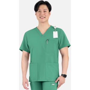 A green men's V-neck top featuring four pockets and a logo, modelled by a smiling individual.