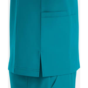 A teal V-neck top featuring four pockets and side slits for added comfort.
