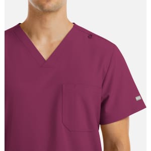 A maroon V-neck top with four pockets and a logo on the shoulder. Features a plain design suitable for various settings.