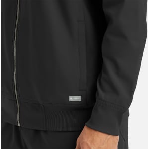 A black full zip bomber jacket featuring ribbed cuffs and a side pocket, with a logo on the hem.