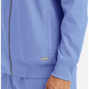 A men's full zip bomber jacket in light blue with side pockets and a ribbed cuff. Features a branding logo.