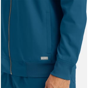 A full zip bomber jacket in a deep blue colour with a ribbed cuff and side pockets. Features a logo on the front.