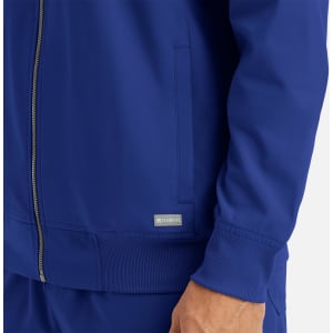 A men's full zip bomber jacket in blue featuring a ribbed collar and cuffs, with a logo on the side.