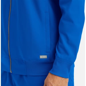 A full zip bomber jacket in vibrant blue featuring a ribbed collar and cuffs, with a small logo on the side.