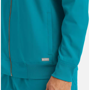 A teal full zip bomber jacket featuring a fitted waistband and cuffs, with a small logo on the side.