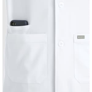 A white mid-length lab coat featuring two front pockets, one holding a phone, and a small logo on the lapel.
