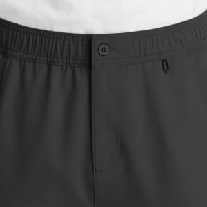 A pair of black men's cargo pants featuring a fly front and an elastic waistband.