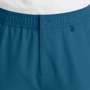 A pair of men's cargo pants in a teal colour featuring a fly front and an elastic waistband. Includes a button and a logo.