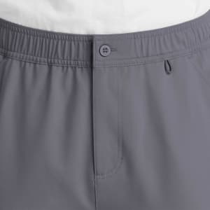A pair of grey cargo pants featuring a fly front with a button closure and an elastic waistband.
