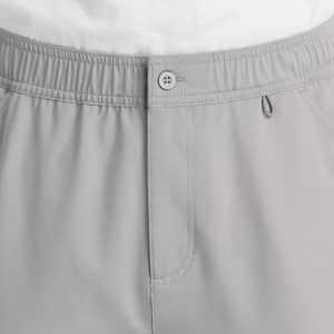 Men's fly front cargo pant in light grey, featuring an elastic waistband and a button closure. Includes pockets and a logo.