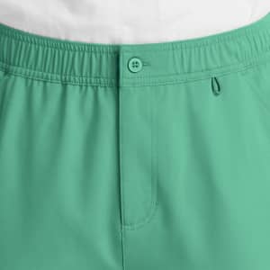 A pair of men's cargo pants in a vibrant green colour, featuring a fly front and elastic waistband.