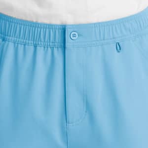 Light blue cargo pants featuring a fly front, button closure, and an elastic waistband. Includes pockets and a logo.