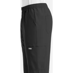 A pair of black full elastic joggers with side pockets and a logo on the leg.