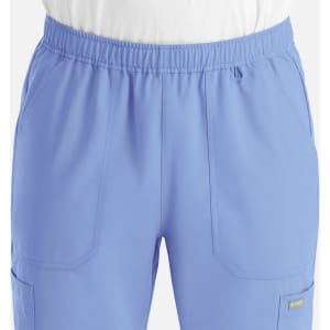 A pair of men's full elastic joggers in a light blue colour, featuring side pockets and an elastic waistband.