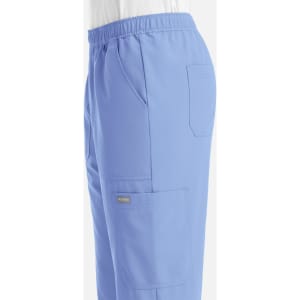 A pair of light blue joggers featuring an elastic waistband and side pockets, with a logo on the fabric.