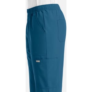 A side view of men's joggers in a deep blue colour, featuring an elastic waistband and pockets.