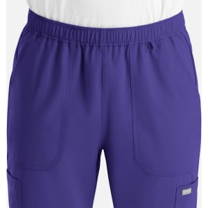 A pair of purple full elastic joggers featuring two front pockets and a logo.