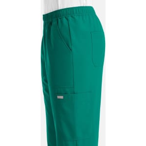 A pair of green joggers featuring an elastic waistband and side pockets, with a small logo on the leg.