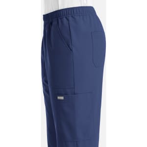 A pair of navy blue men's joggers with full elastic waistband and multiple pockets. Features a branding logo.
