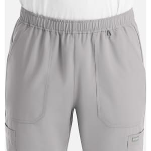 A pair of grey men's joggers with an elastic waistband and side pockets. Kid-friendly fabric is featured.