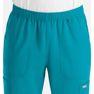 A pair of men's joggers in bright teal, featuring an elastic waistband and pockets, with a logo present.