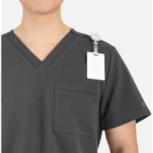 A grey V-neck top featuring contrast piping and a chest pocket, with a badge holder on the shoulder.