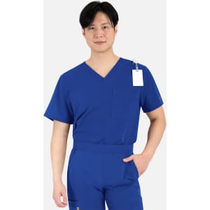 A man wears a royal blue V-neck top with a pocket and a tag, featuring a comfortable fit.