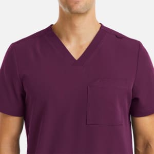 A men's v-neck top in a deep purple shade featuring three pockets and a shoulder snap. It has a logo on the fabric.