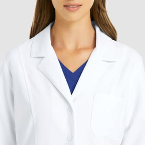 A white women's lab coat with a classic collar, featuring a single chest pocket and a button closure.