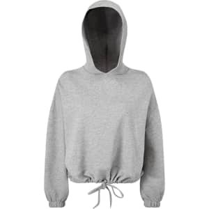 A cropped oversize hoodie in light grey with a drawstring hem and a hood. It features a logo on the front.