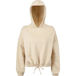 A cropped oversize hoodie in a light beige colour, featuring a hood and adjustable drawstring at the hem.