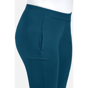 A pair of mid-rise tapered pants in teal, featuring side pockets and a smooth waistband. Includes a logo on the waistband.