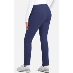 A mid-rise tapered pant in navy blue, featuring a fitted design and a rear view. The model is wearing grey shoes.