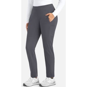 Mid-rise tapered pants in dark grey with a side pocket, paired with a white long-sleeve top and white shoes.