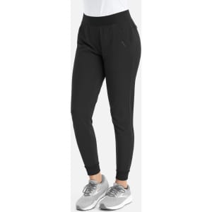 Mid-rise elastic jogger in black, featuring a tapered fit and a logo. Paired with grey athletic shoes.