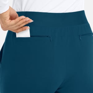 A pair of teal joggers featuring a mid-rise elastic waist and a small pocket at the back.