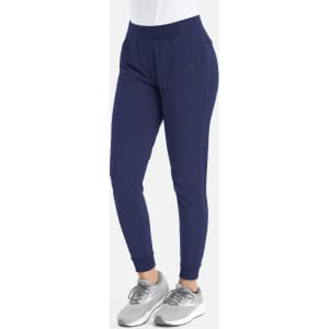 A pair of navy mid-rise joggers with an elastic waistband and cuffs, featuring a logo.