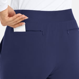 A pair of navy mid-rise joggers featuring elastic waist and two back pockets, one with an item inserted.