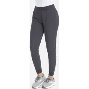 A pair of grey mid-rise elastic joggers with a fitted design and side pockets. Features an elastic waistband.