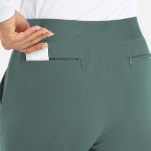 A close-up of a mid-rise elastic jogger in green, featuring a pocket on the back.
