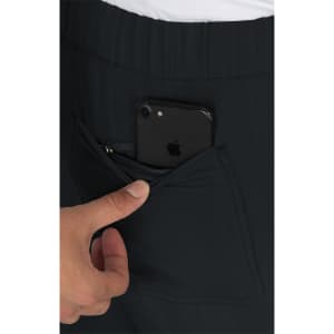 A pair of black pants featuring a zippered pocket with a smartphone partially visible inside.
