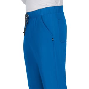 A pair of bright blue pants with a drawstring waistband and side pockets, featuring a logo.