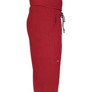 A pair of red cargo pants with pockets and an elastic waistband is displayed in profile view.