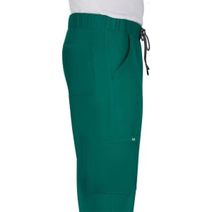 A pair of teal pants with an elastic waistband and pockets, featuring a drawstring detail.
