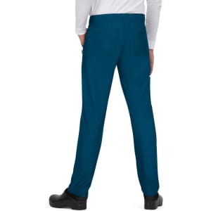 A pair of teal pants with a stretchy waistband and two back pockets, worn by a person from the back.